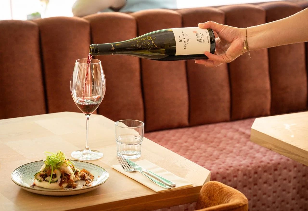 Pouring an elegant white wine into a glass